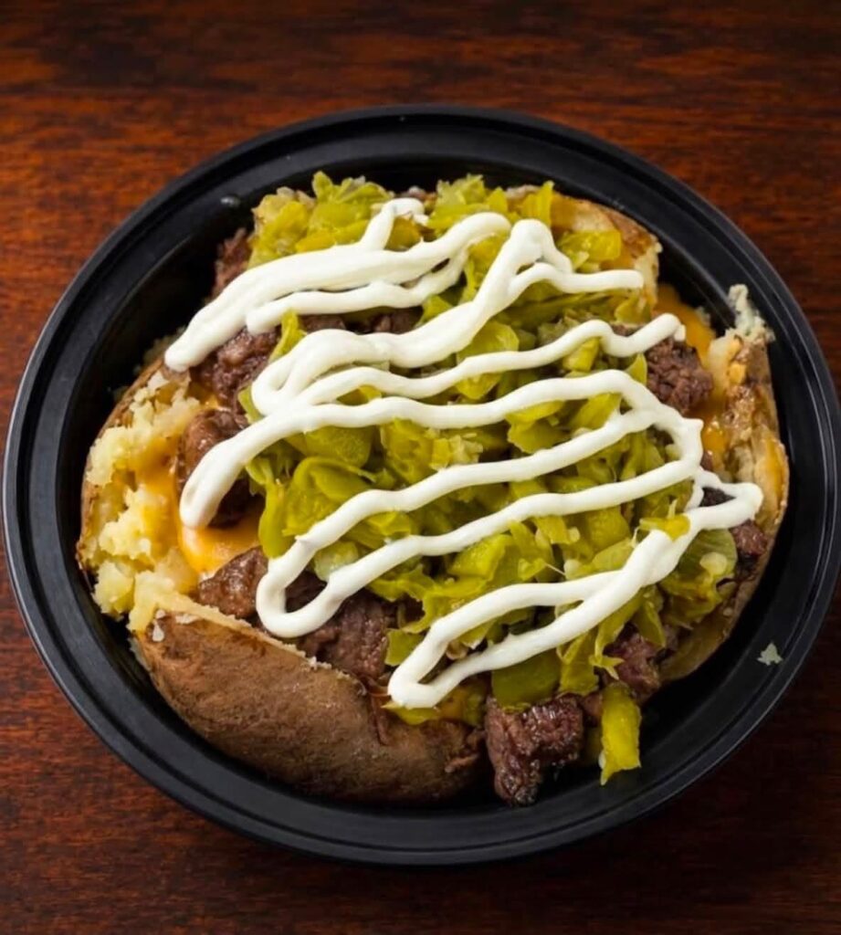 Loaded Baked Potato Bowl Topped with Seasoned Steak, Chopped Green Peppers, Melted Cheese, and Sour Cream Drizzle | O-Daddy's Brick Oven Sandwiches
